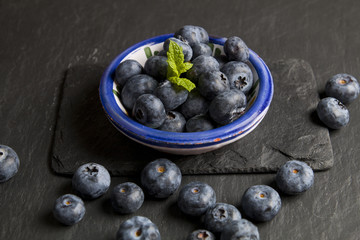 Blueberries on a dark stone background