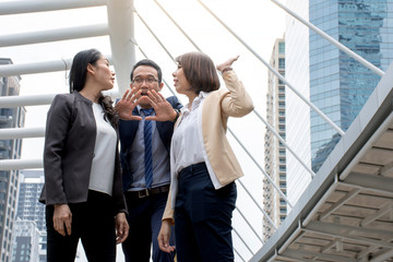 Portrait of Aggressive young Asian women in formal wear or businesswoman fighting while man...