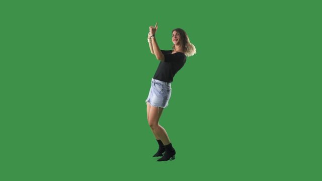 Attractive young woman fashion model posing with finger frame gesture isolated on green screen