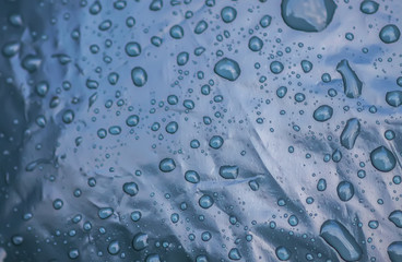 Wet plastic surface with drops of rain