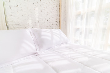 Bed in the morning with natural light from the window. Bedding room background.