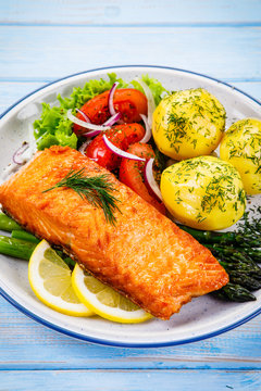 Grilled salmon with boiled potatoes, asparagus and vegetable salad