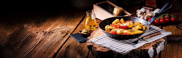 gnocchi baked with green pesto, cherry tomatoes and parmesan