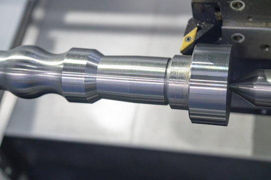 The CNC lathe machine or turning machine cutting the aluminum rod . Hi-technology manufacturing process.
