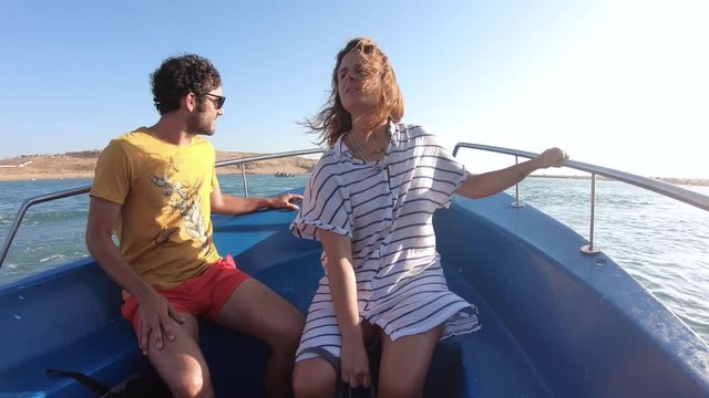 Adventurous tourists couple travel by boat to an amazing deserted beach