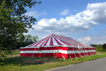 Large party Marquee, red and white stripped event tent set in the countryside.