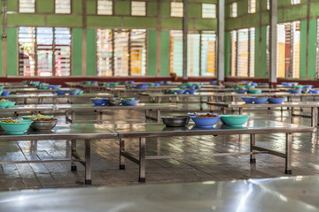 Decked tables waiting for monks at Mahagandayon monastery, Myanmar.