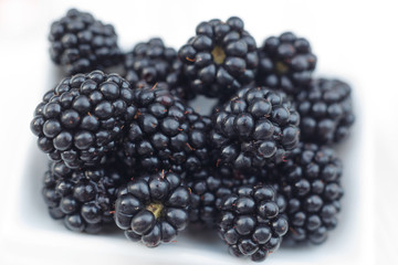 Background from fresh Blackberries, close up. Lot of ripe juicy wild fruit raw berries lying on the table. Top view, Flat lay