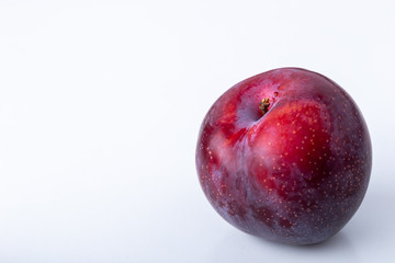 A purple plum isolated on a white background