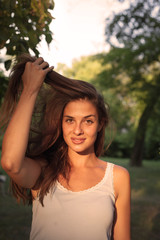 Naklejka premium Close-up young woman with beautiful face features enjoying sun