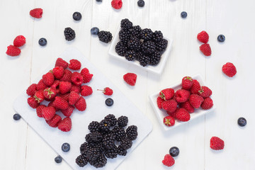 Blueberries, raspberries and blackberries on white background