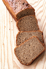 Freshly baked rye bread. Sliced on wooden. Top view. Close up.