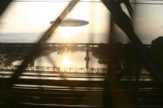 Ufo see from a running car on a bridge, photo manipulation 