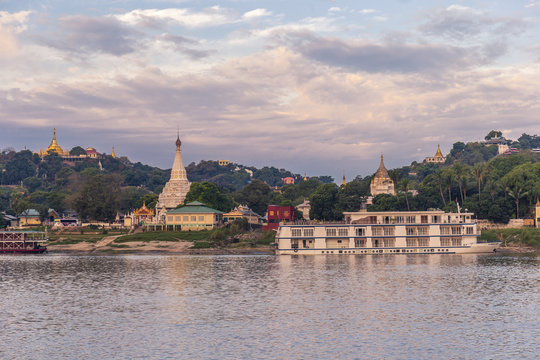 Pagodas gleam on the serene riverbanks of the Irrawaddy in Myanmar