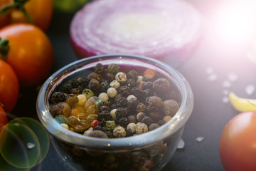 Close up of colorful spices and fresh vegetables for cooking on dark metal background with space for text. Top view. Bio Healthy food ingredients.