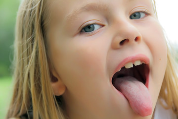 Small girl with put out tongue