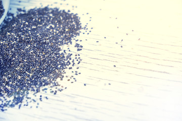 Healthy Chia seeds in a wooden spoon on the table close-up. horizontal