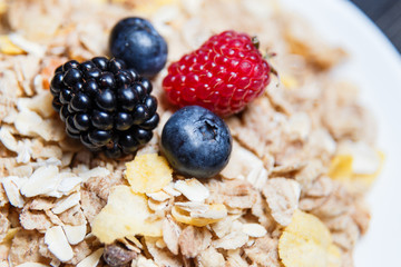 Healthy breakfast. Raspberries, blueberries, blackberries on a cereal