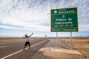 Homme et Panneau signe Tropique du Capricorne dans le désert d' Atacama au Chili 
