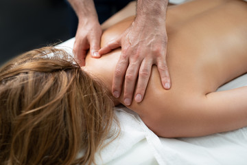 Gentle touch. Close up portrait of naked woman lying on massage table during spa procedure....