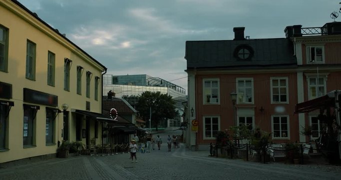 Timelapse of people walking on a small street crossing the canal in central Västerås.