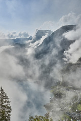 Fototapeta na wymiar Scenic view of misty mountains above Halstatt village in Austria.