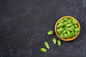 hop cones  in a wooden plate, top view