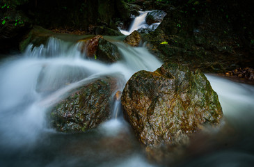 Big rock in the forest at Nangrong Waterfall, Nakhon Nayok province, Thailand with long exposure in the morning.