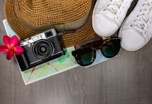 People always travel during holiday. Their accessories usually are hat, sunglasses, camera, map, and comfort shoes.  