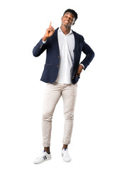 Obraz premium Full body of Handsome african american man wearing a jacket counting number one sign on white background