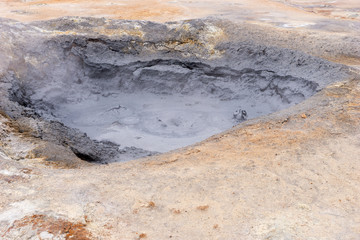 Fototapeta na wymiar Gray hot mud pots in the Geothermal Area Hverir in Iceland