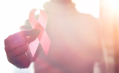 The red ribbon of the girl. The girl is holding a red ribbon. He