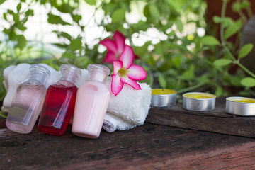 soap and shampoo on  table, flower on white cloth,