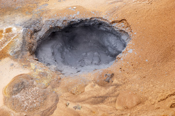 Gray hot mud pots in the Geothermal Area Hverir in Iceland