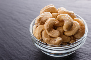 cashew nuts on a dark stone background