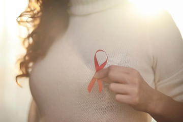 The red ribbon of the girl. The girl is holding a red ribbon. He