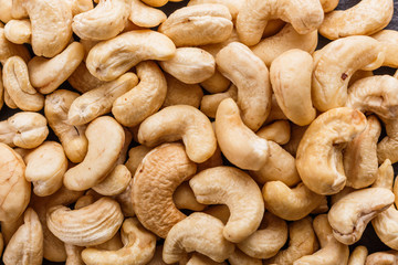 cashew nuts on a dark stone background
