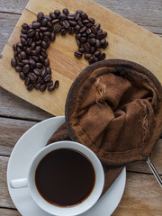 Hot coffee in cup background, raw coffee on wooden,
