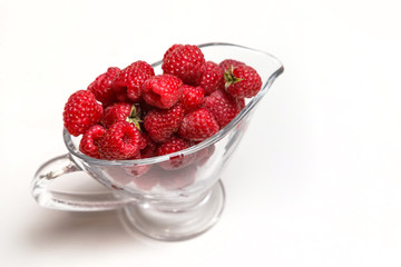 fresh raspberries in glass on isolated background