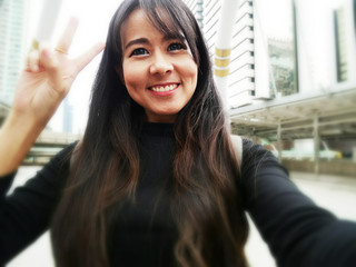 Beautiful woman take photo selfie and blur background.