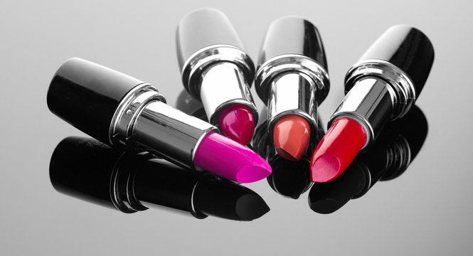 Lipstick. Professional makeup and beauty. Lipstick tints palette closeup. Colorful lipsticks over black background