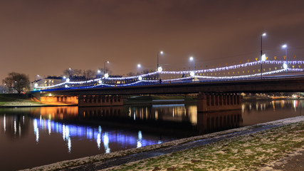 Fototapeta na wymiar Christmas decorations on the Grunwaldzki bridge in Krakow