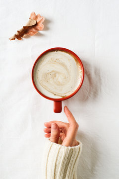 Minimalism composition with cup of coffee and hand