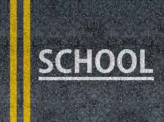 Word SCHOOL written with paint on road asphalt