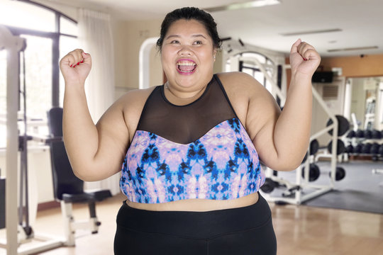 Fat woman expressing her success to lose weight