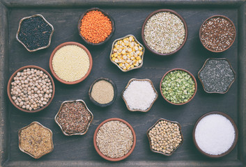 Gluten-free concept. Grains, cereals and seeds for baking. Millet, quinoa, corn, buckwheat, rice, amaranth, chickpea, coconut, chia, soy, oats, lentils. Healthy food. Top view.