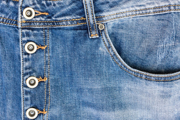 Fototapeta premium Pocket of jeans, Clasp jeans for metal buttons, Close up of details of jeans trousers with orange stitches. orange seam on jeans.