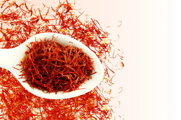 saffron in spoon on white background for food and flavor extract concept,flat lay