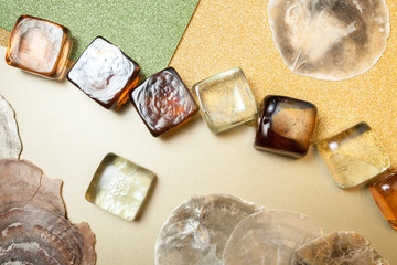 seashells and glass cubes on shiny background
