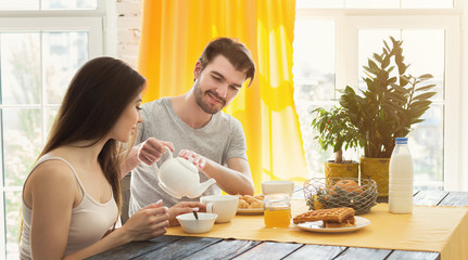 Happy loving couple having breakfast in the morning